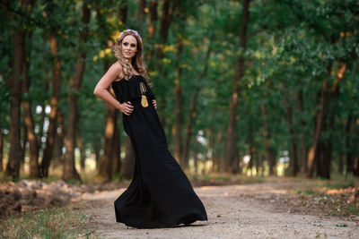 Full length portrait of woman in forest