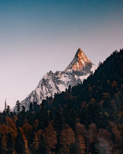 Scenic view of snowcapped mountains against clear sky