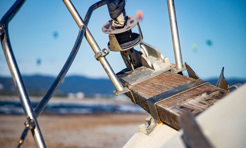 Close-up of sailboats moored on sea against sky