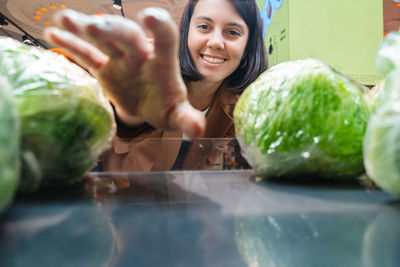 Portrait of smiling young woman holding food