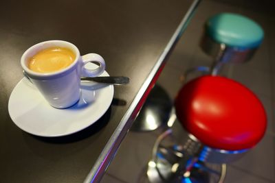 Close-up of coffee on table by seat