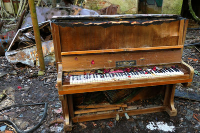 High angle view of abandoned piano on field