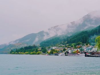 Scenic view of sea and mountains against sky