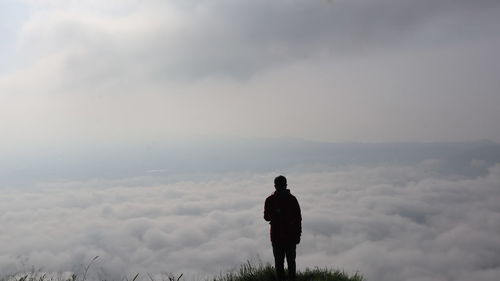 Rear view of man standing against sky