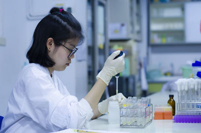 Scientist working at table in laboratory