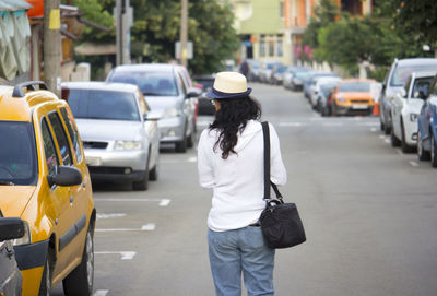 Rear view of man walking on city street