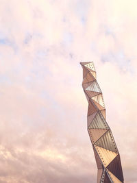 Low angle view of tower against cloudy sky