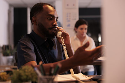 Side view of young man smoking cigarette