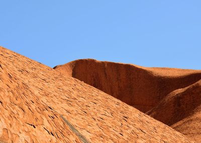 Scenic view of desert against clear blue sky