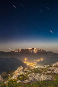 Scenic view of mountains against sky at night