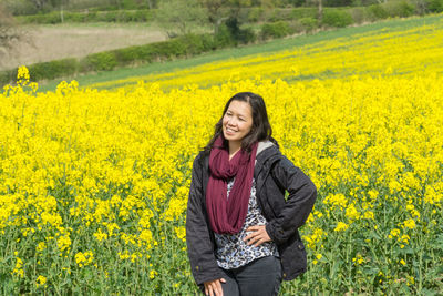 Portrait of young woman standing in field