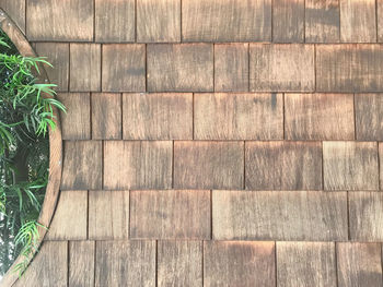 High angle view of wooden wall with plant container