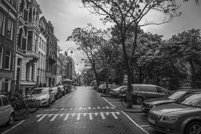 Cars on street amidst buildings in city