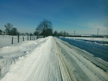 Snow covered landscape against clear sky