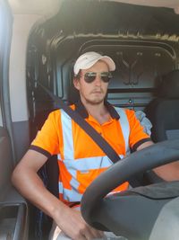 Mid adult man sitting in car