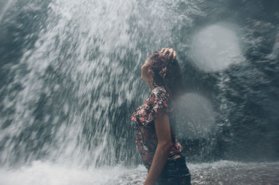 Woman standing in sea water