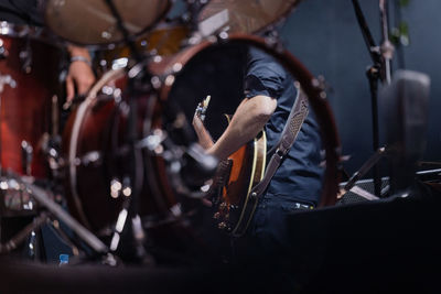 Reflection of a guitarist in a drum