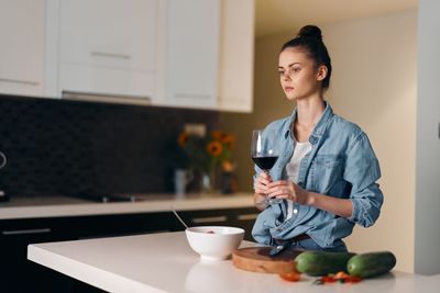 Young woman using mobile phone at home