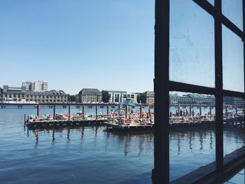 View of badeschiff on spree river against clear sky seen from window