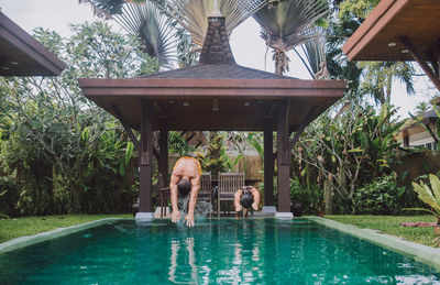 People standing by swimming pool in park