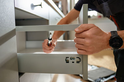 Cropped hand of man working at home