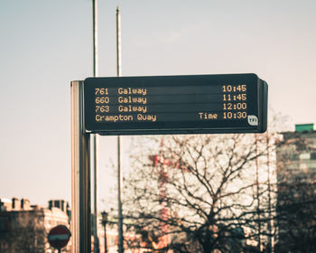 Low angle view of information sign against sky