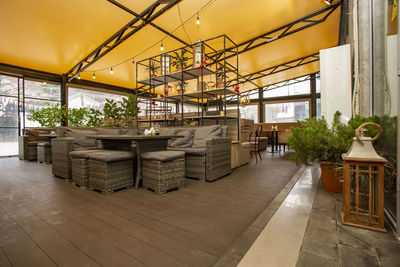 Empty chairs and tables in building