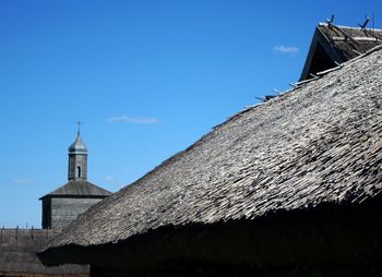 Low angle view of bell tower against clear blue sky