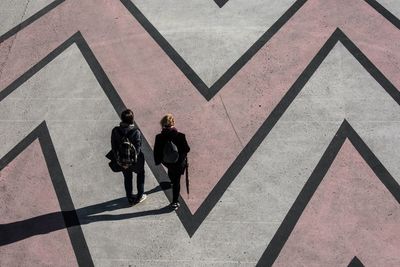 High angle view of people walking on zebra crossing