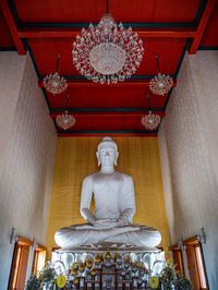 Low angle view of statue against illuminated building