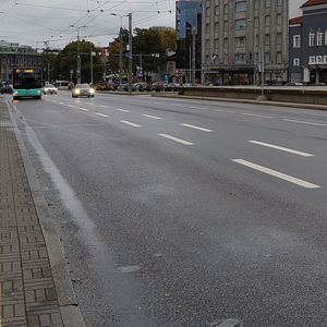 Cars on road against sky in city