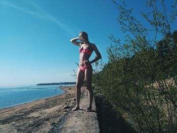 Woman on beach against sky