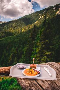 Food in plate on table against mountain