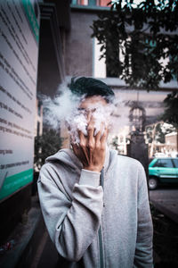 Portrait of man smoking at home