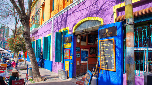 Multi colored buildings by street in city