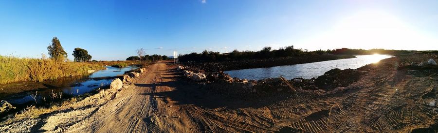 Panoramic shot of river against clear blue sky