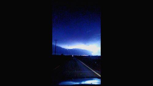 Road against sky at night