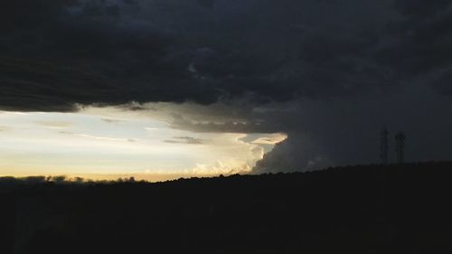 Silhouette of landscape against cloudy sky