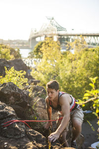 Two friends rock climbing together on summer day