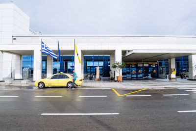 Taxi outside athens international airport against sky