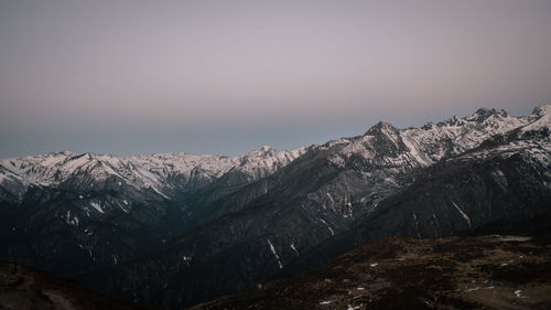 Scenic view of snowcapped mountains against clear sky