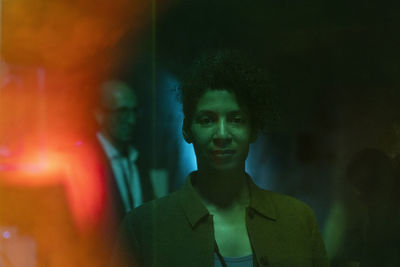 Portrait of businesswoman in illuminated exhibition center