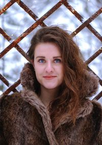 Portrait of smiling woman with snow during winter