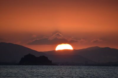 Scenic view of sea against romantic sky at sunset