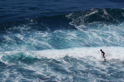 High angle view of man surfing in sea