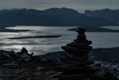 Stack of rocks on shore against sky