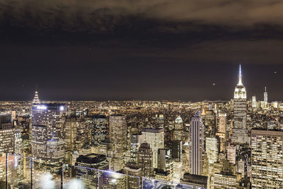 Aerial view of city lit up at night