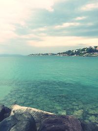 Scenic view of sea against cloudy sky