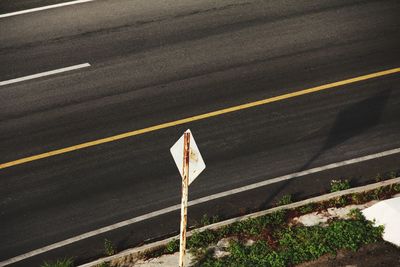 High angle view of road sign on street