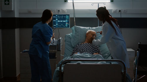 Doctor and nurse examining patient in hospital